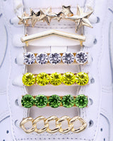White Nike Air Force 1 and Jordan 1 sneakers with gold,  pearls, yellow and green rhinestone shoelace charm decorations
