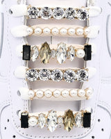 White Nike Air Force 1 and Jordan 1 sneakers with gold,  pearls, black rhinestone shoelace charm decorations