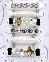 White Nike Air Force 1 and Jordan 1 sneakers with silver,  pearls, black rhinestone shoelace charm decorations