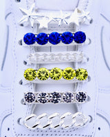 White Nike Air Force 1 and Jordan 1 sneakers with silver,  pearls, yellow and blue rhinestone shoelace charm decorations