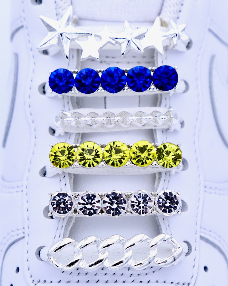 White Nike Air Force 1 and Jordan 1 sneakers with silver,  pearls, yellow and blue rhinestone shoelace charm decorations