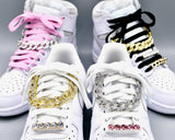 Gold and silver iced cuban chains for sneakers on white Nike Air Jordan 1's and Air Force 1's (AF1) with pink and black shoelaces, and rhinestone lace charms