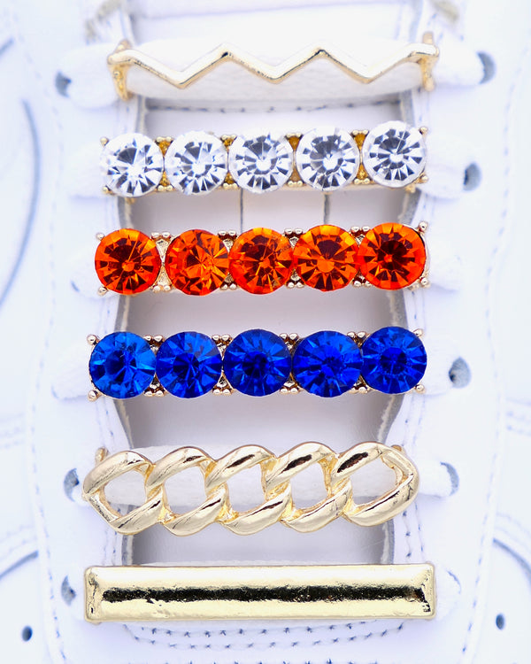 White Nike Air Force 1 and Jordan 1 sneakers with gold,  pearls, blue and orange rhinestone shoelace charm decorations