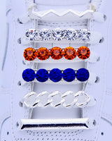 White Nike Air Force 1 and Jordan 1 sneakers with silver,  pearls, blue and orange rhinestone shoelace charm decorations